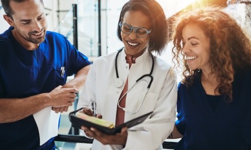 people and a doctor in a bright clinic lobby area