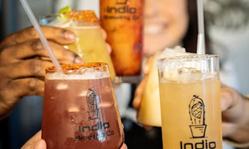 people holding drinks at Indio Brewing 